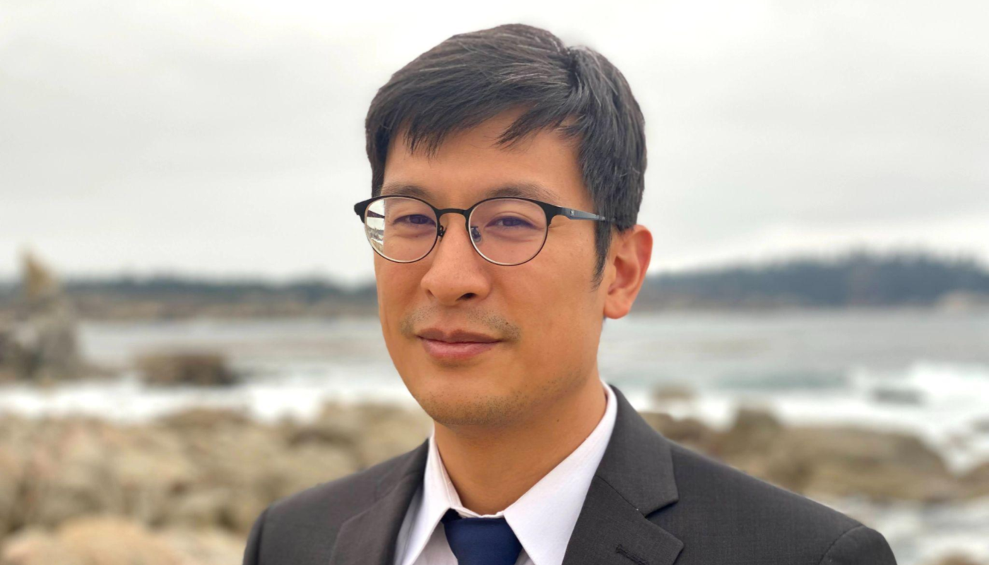 Headshot image of James Chu outdoors on a beach.