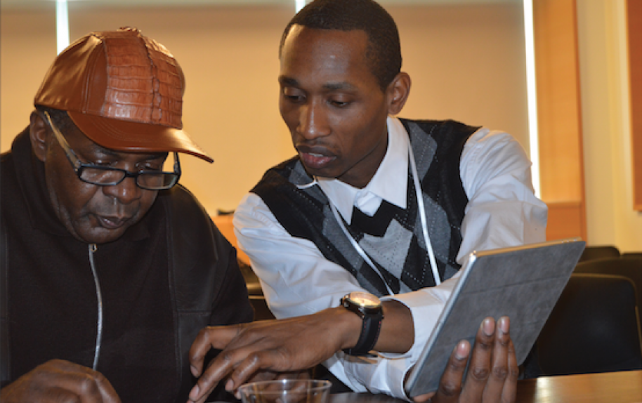 Two men who were formerly in prison create graphic art.